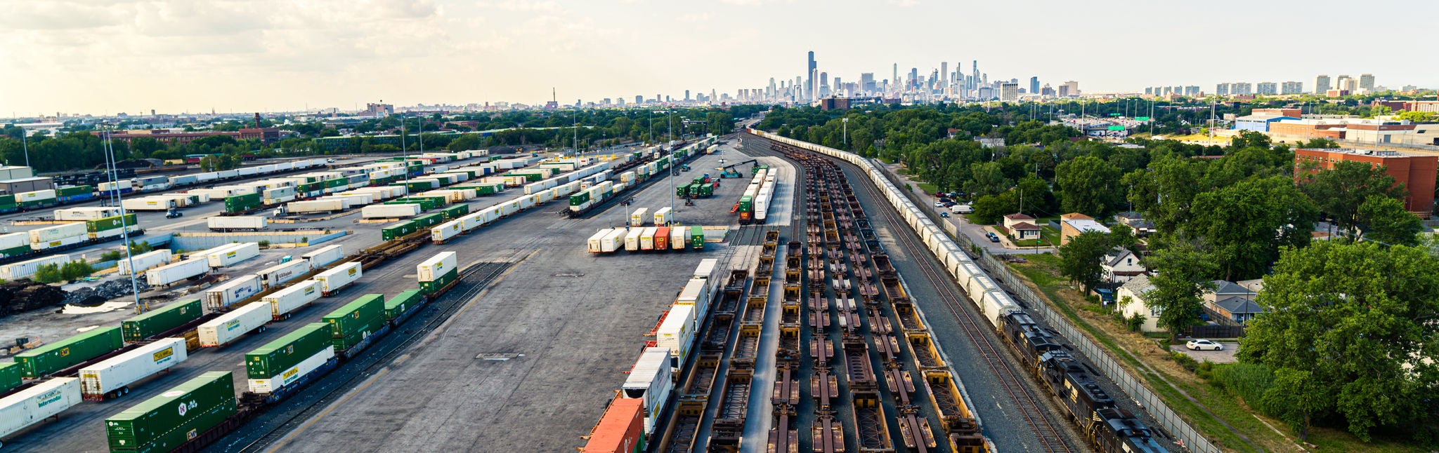 Aerial shot of train yard with 20 or more trains waiting to ship metals by rail
